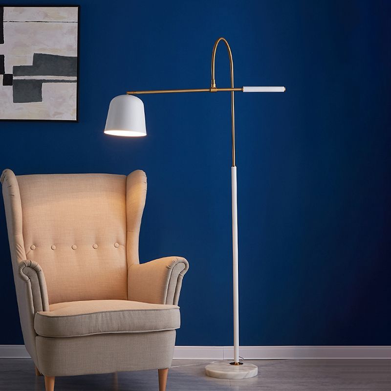 Salgado Modern Arc Bowl Floor Lamp beside beige armchair in living room
