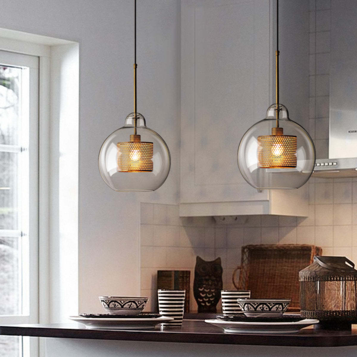Golden globe pendant lights in modern kitchen setting