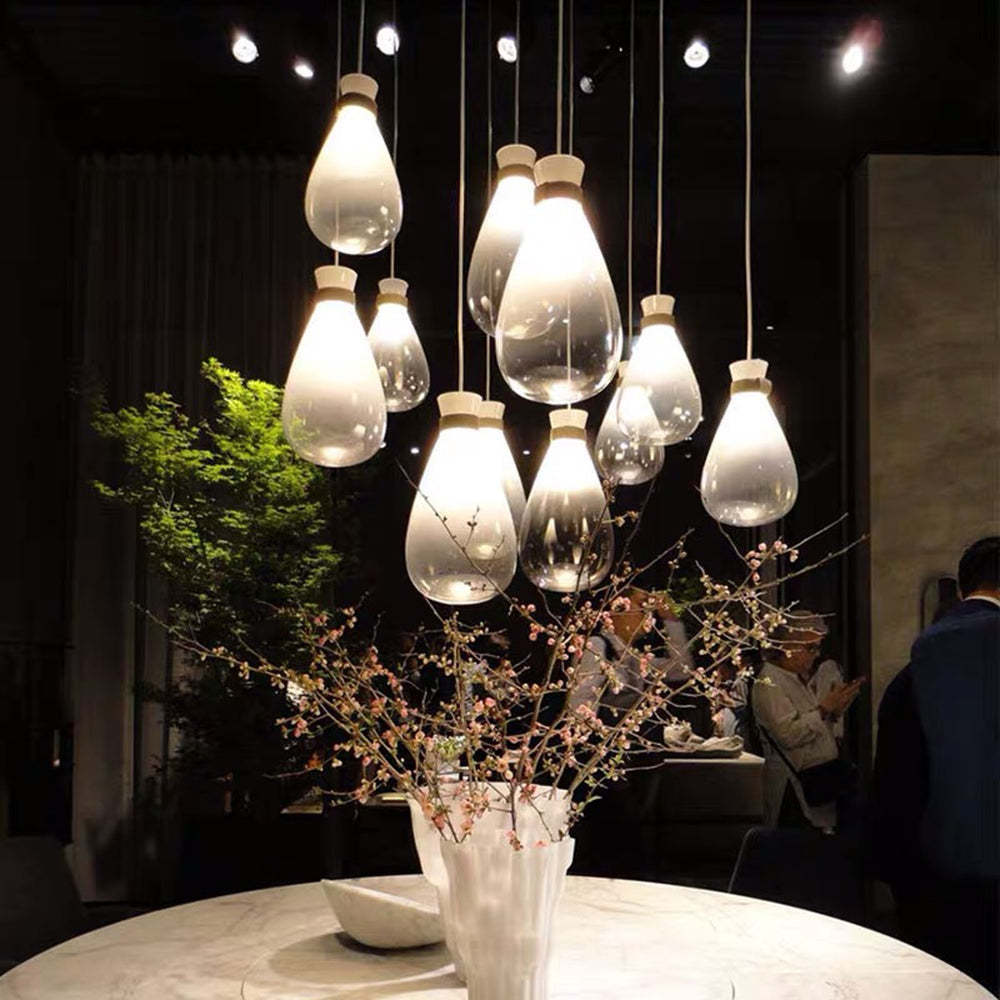 Teardrop glass pendant lights over dining table.