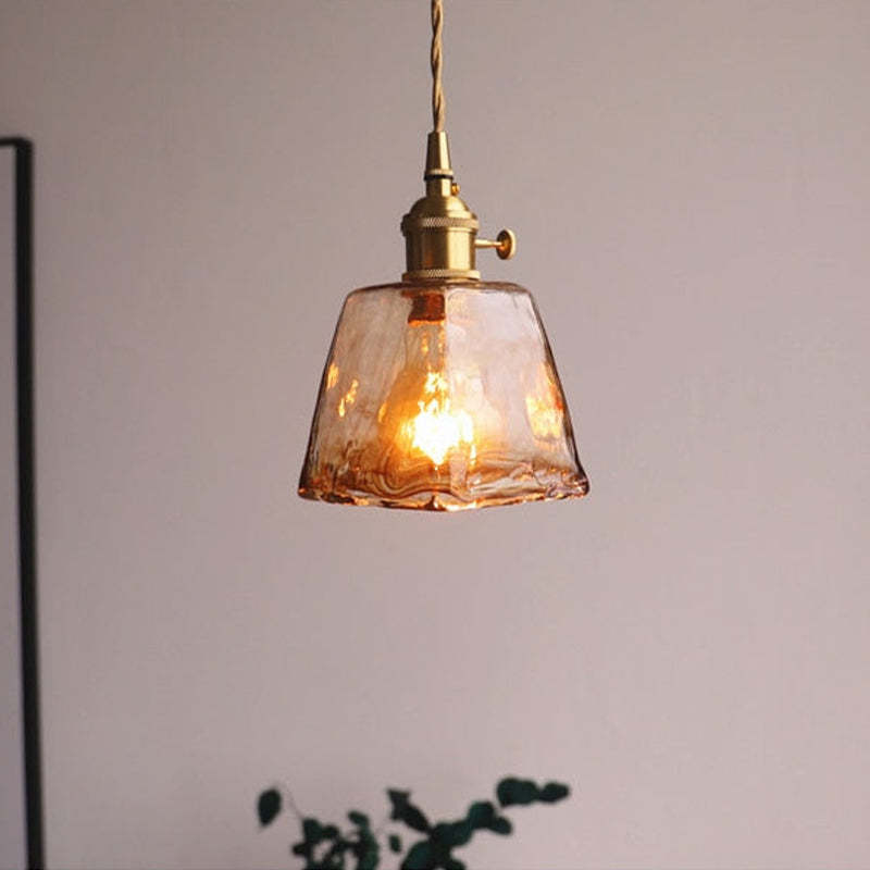 Levy pendant light with caramel glass shade.
