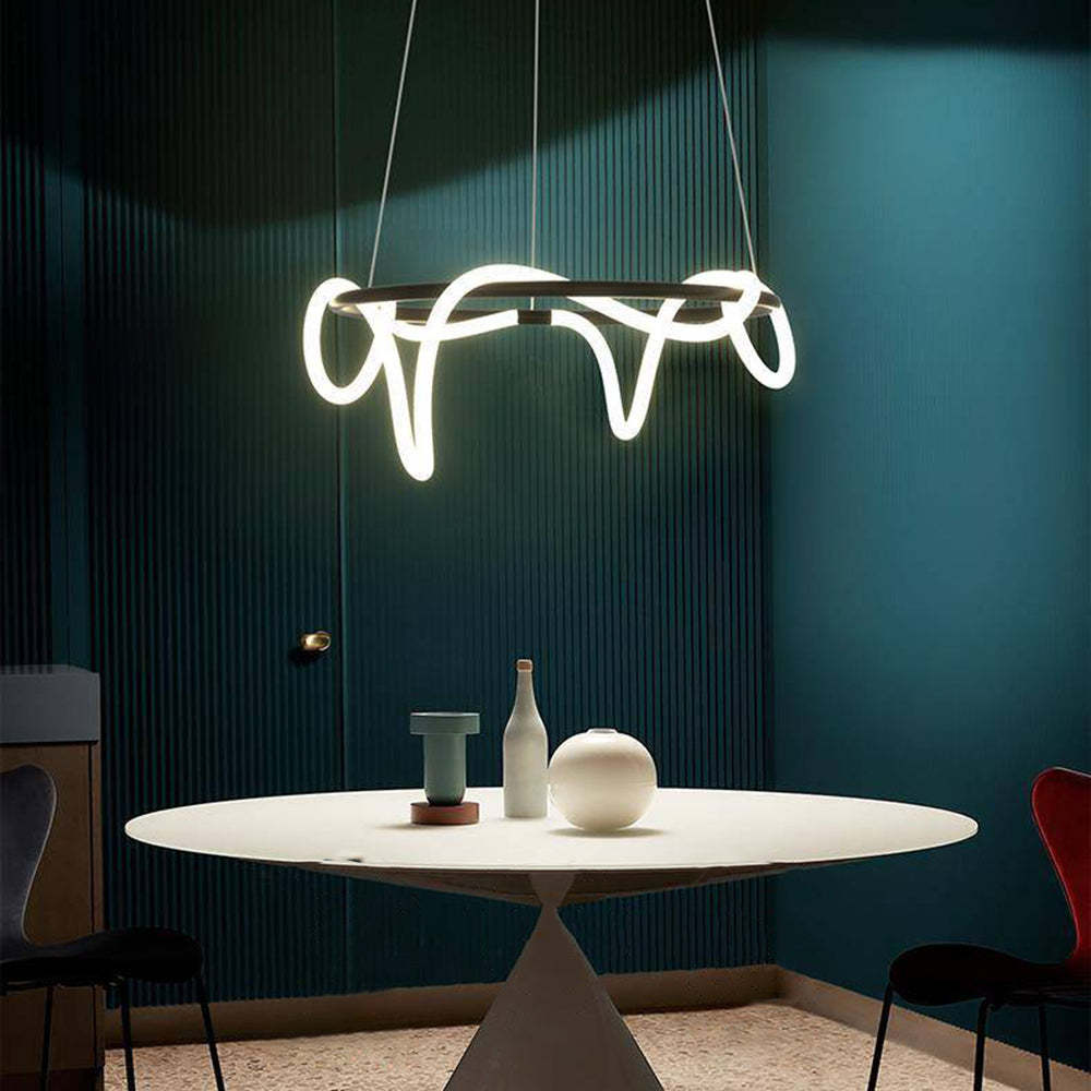 Louise curved LED ceiling light over modern dining table.