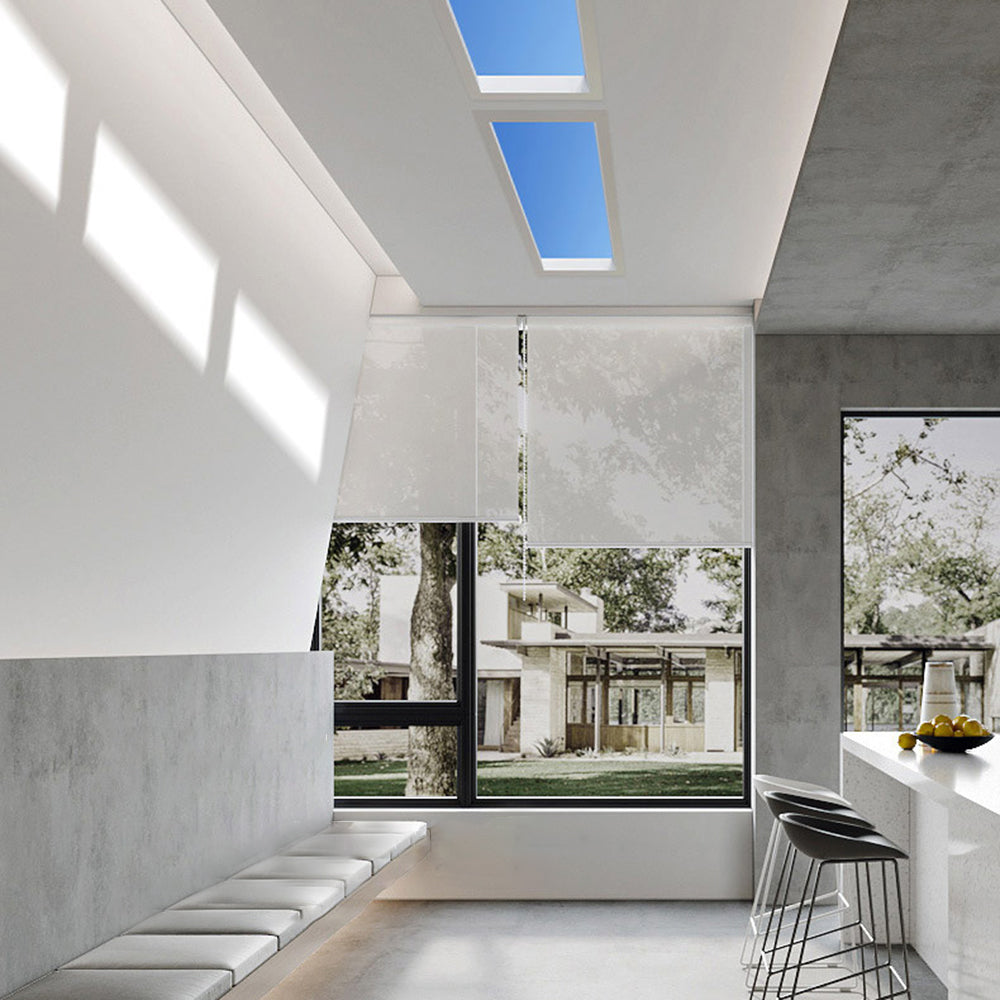 Modern flush mount ceiling light in a bright living room.