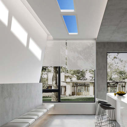 Modern flush mount ceiling light in a bright living room.