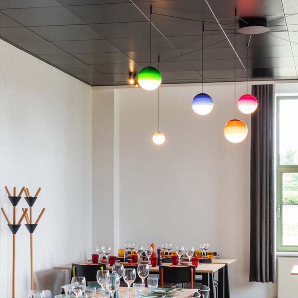 Dining room with colorful glass bubble pendant lights.