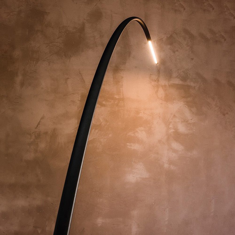 Black metal floor lamp. Edge minimalist design, warm light.