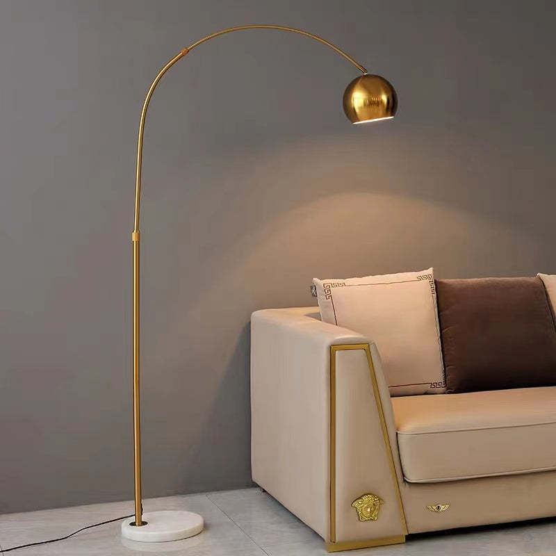 Gold arc floor lamp near sofa. Modern lighting solutions. Morandi Modern Fishing 1 Light Arc Floor Lamp Metal