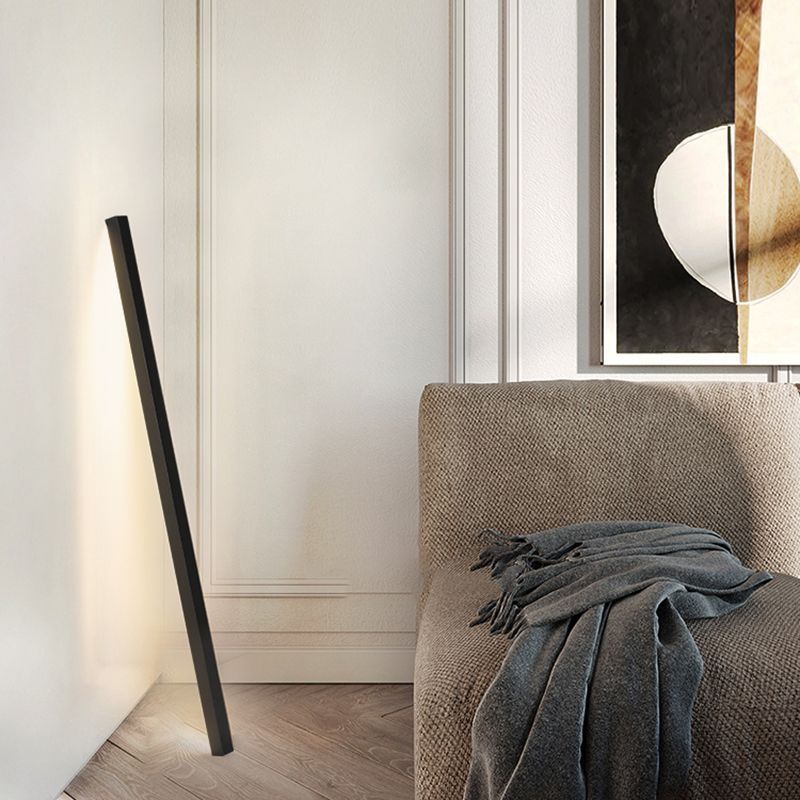 Modern black floor lamp in living room setting with minimalist design