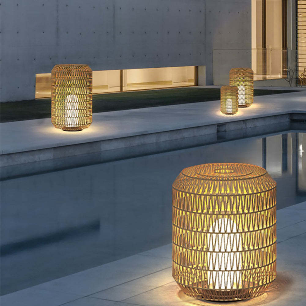 Ritta Rattan Outdoor Floor Lamps illuminating a modern patio