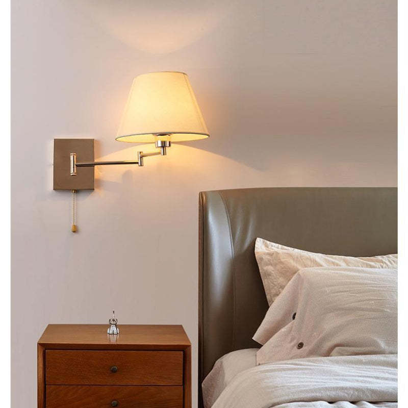 Brady Wall Lamp: Fabric shade on metal arm, bedroom setting