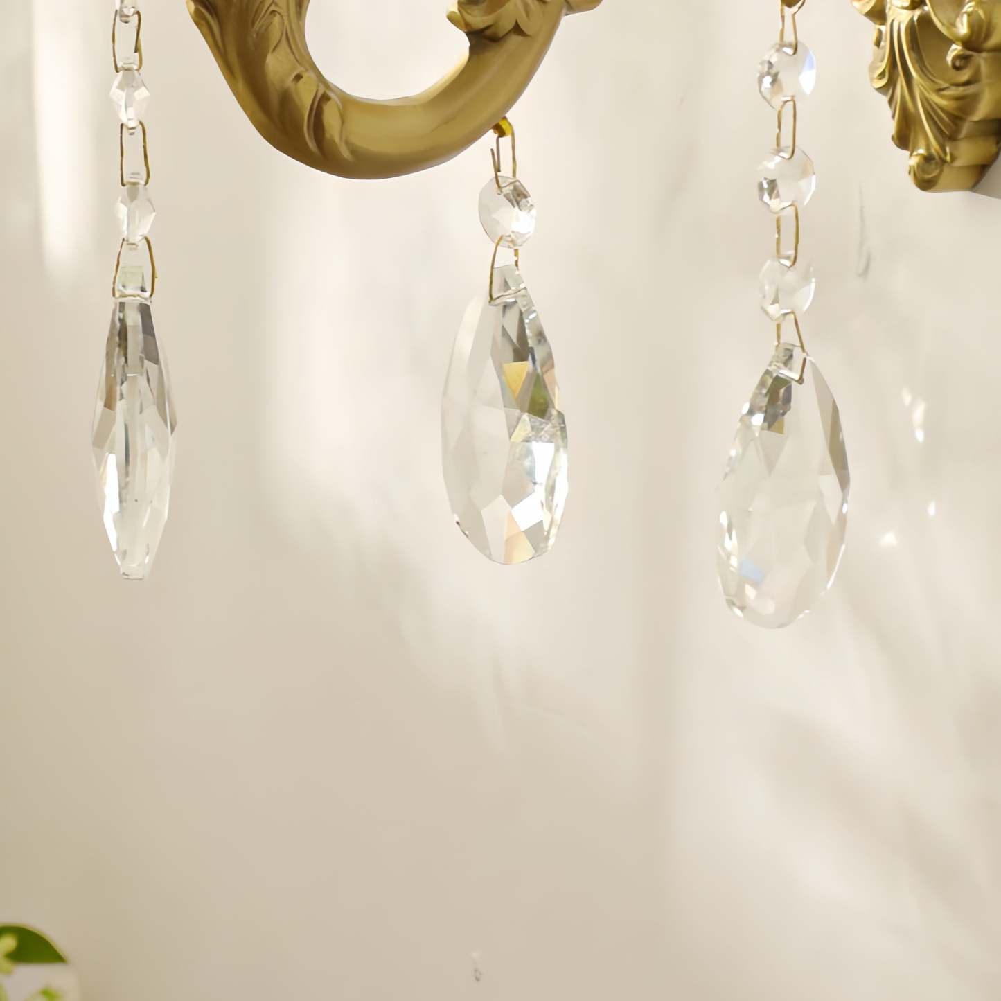 Alessio crystal wall light with brass finish