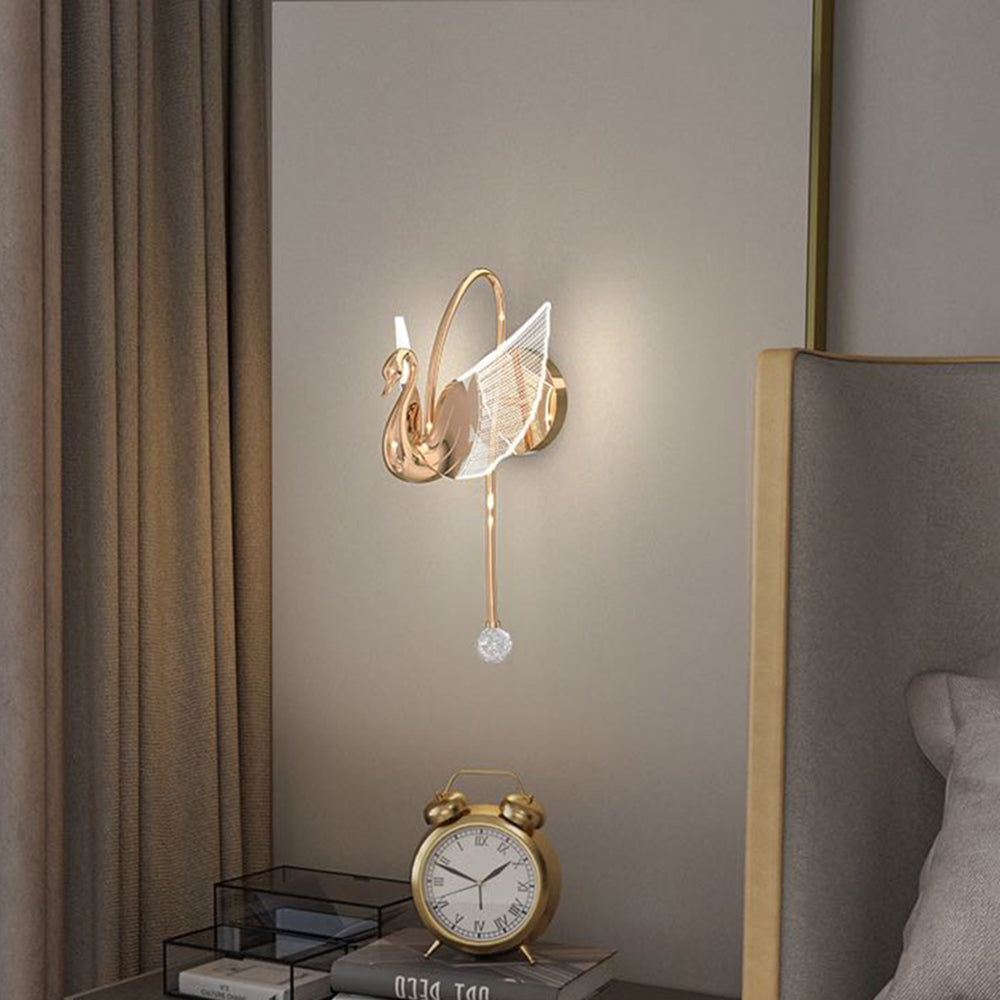 Elegant gold swan wall lamp in a bedroom setting
