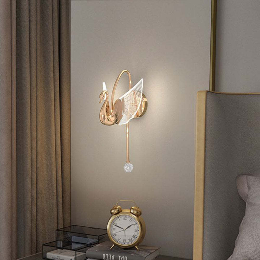 Elegant gold swan wall lamp in a bedroom setting