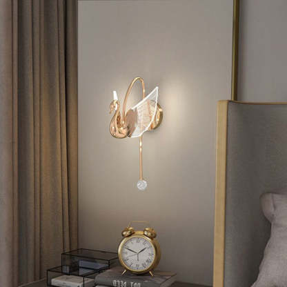 Elegant gold swan wall lamp in a bedroom setting