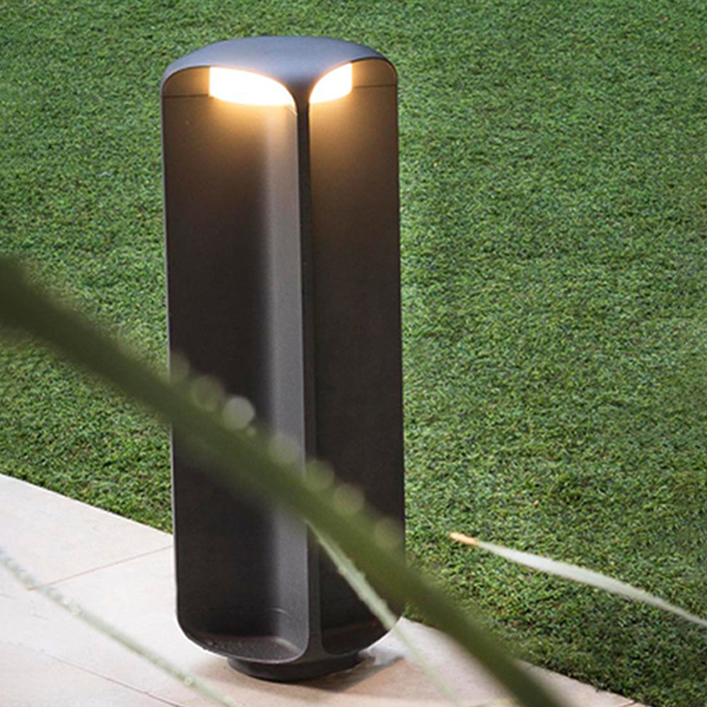 Pena Outdoor Bollard Light illuminating garden