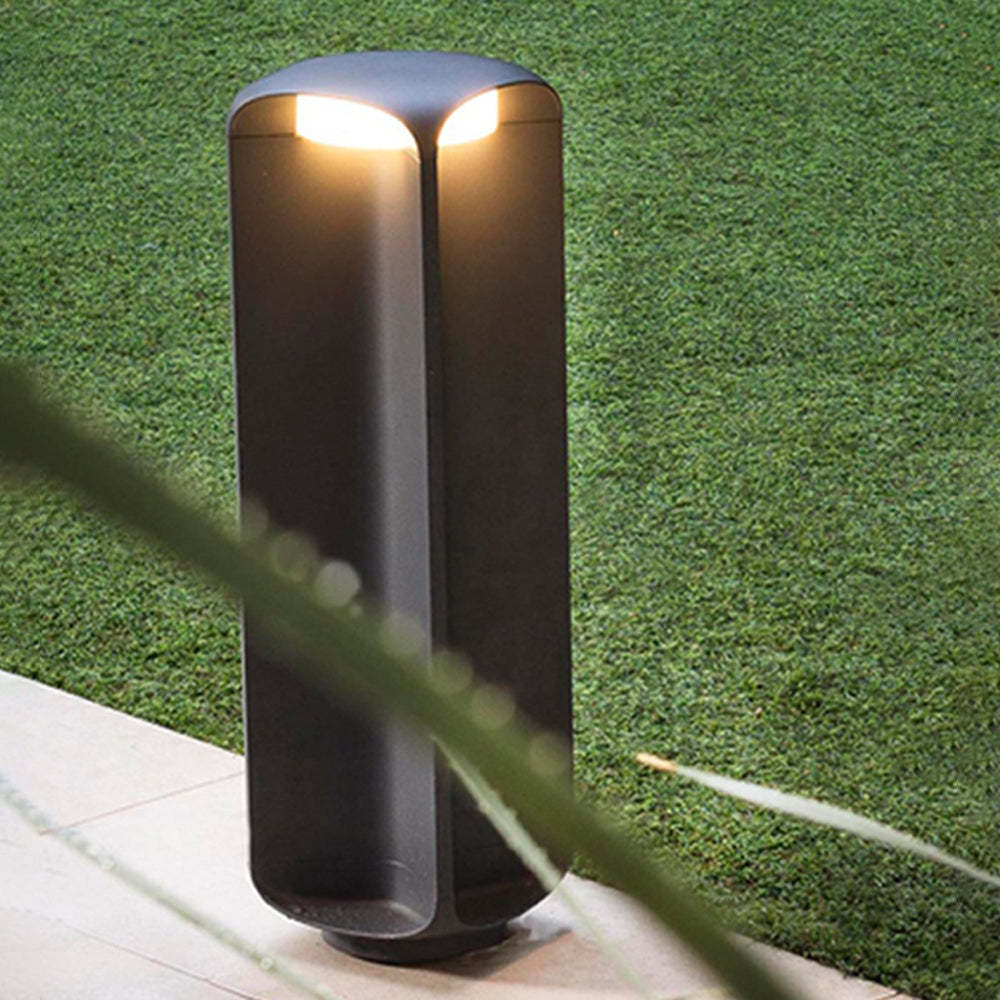 Pena Outdoor Bollard Light illuminating garden