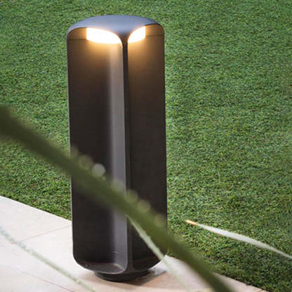 Pena Outdoor Bollard Light illuminating garden