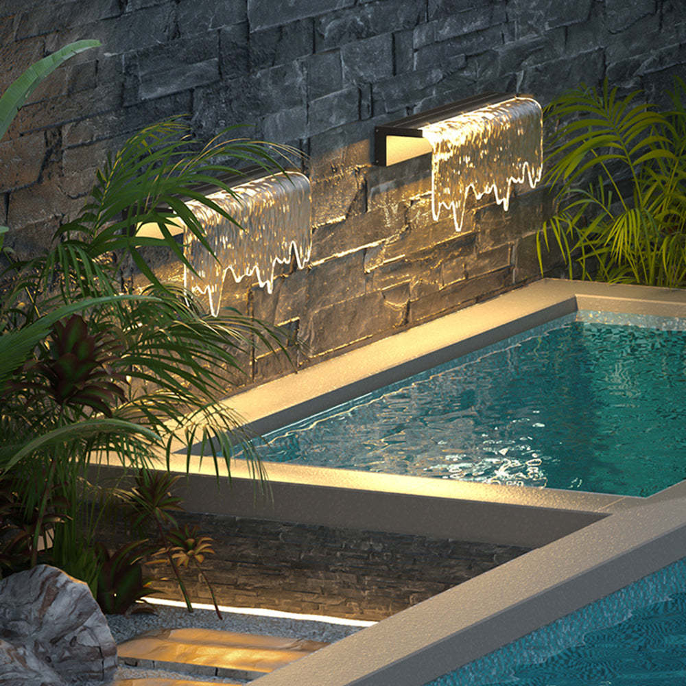 Isaac outdoor wall lamp illuminating a pool and garden