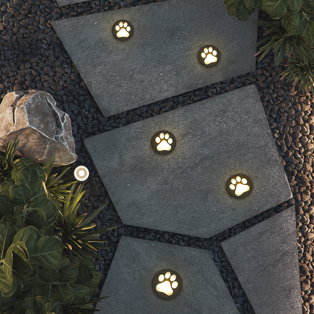 Outdoor pathway with cat paw ground lights, modern garden lighting