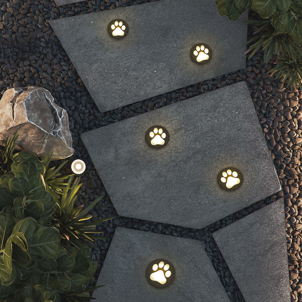 Outdoor pathway with cat paw ground lights, modern garden lighting