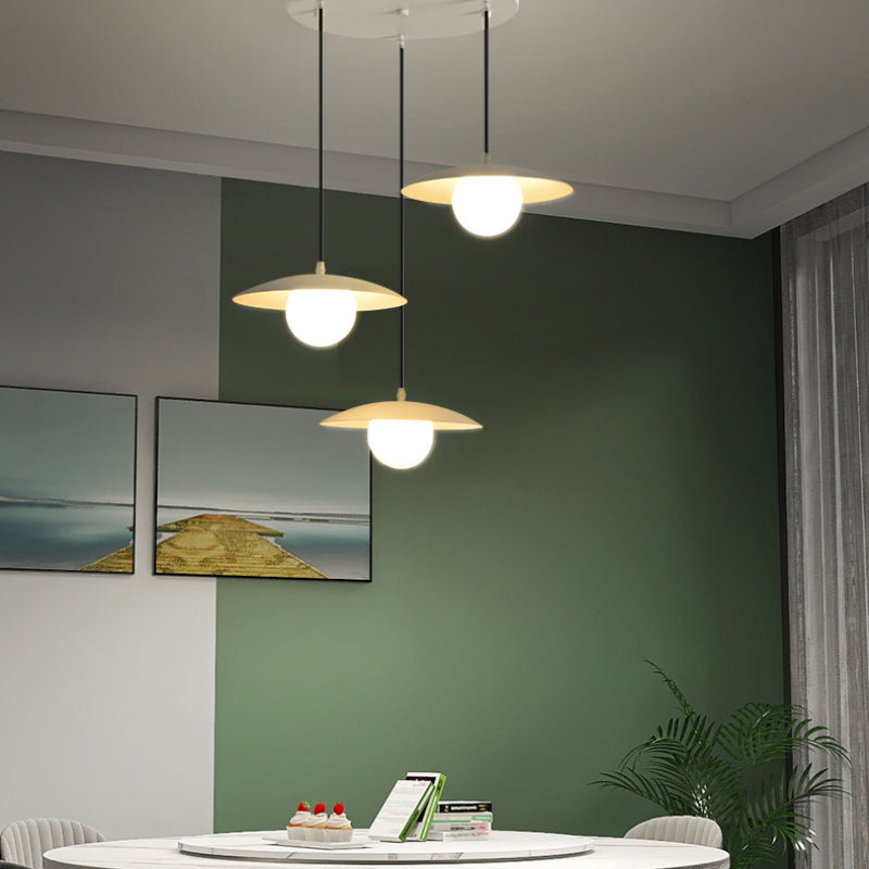 Morandi pendant light fixture over dining table in modern interior
