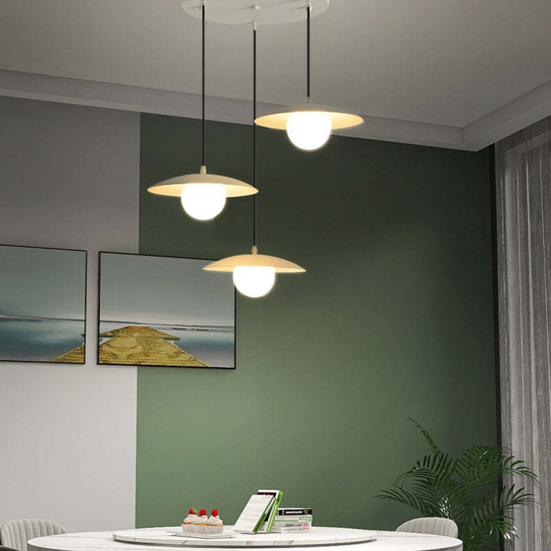 Morandi pendant light fixture over dining table in modern interior
