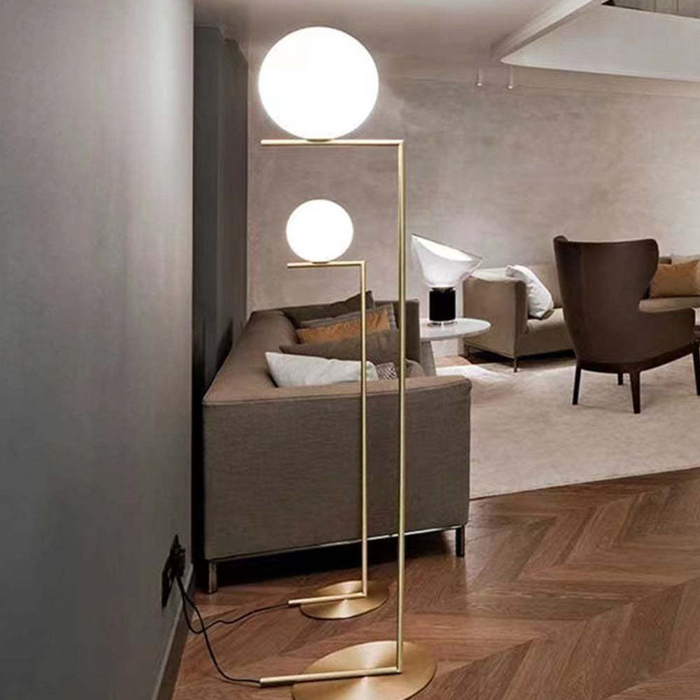 Valentina modern brass floor lamp illuminating a living room