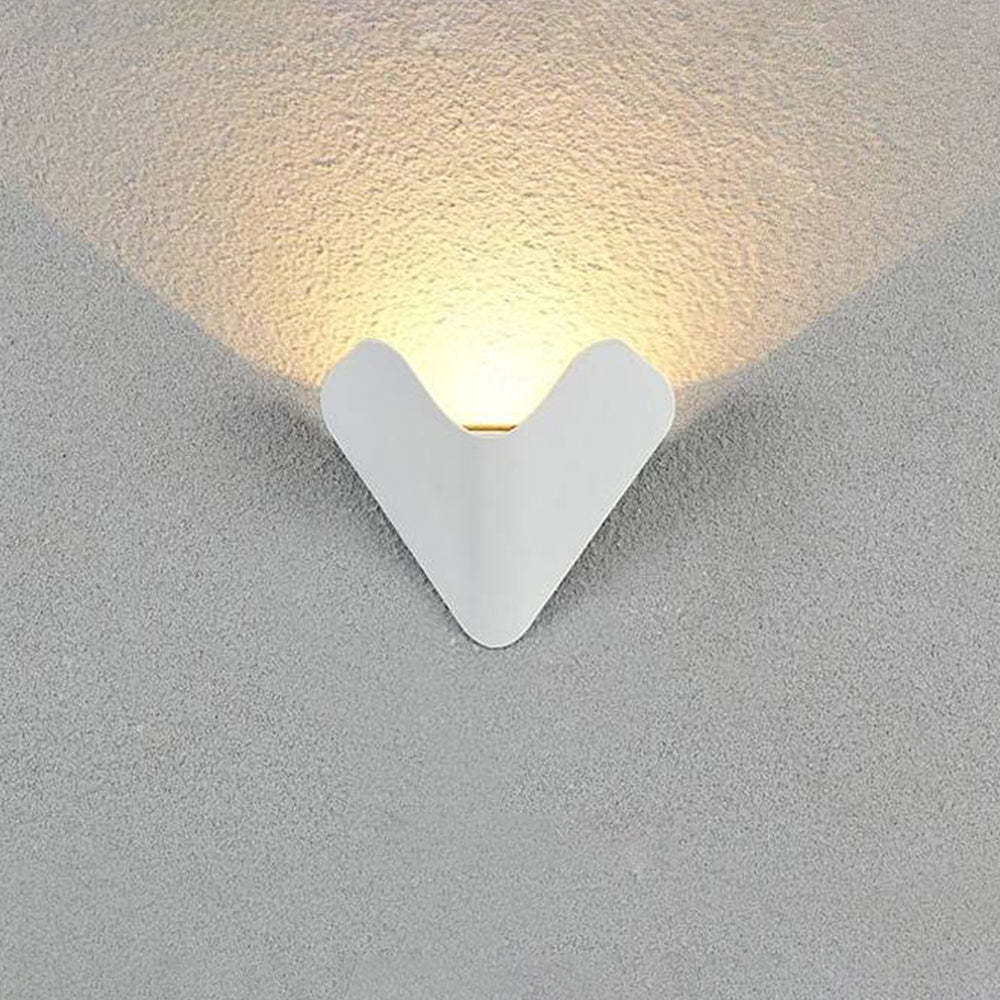 Outdoor Orr Triangle Wall Lamp emitting warm light on textured wall
