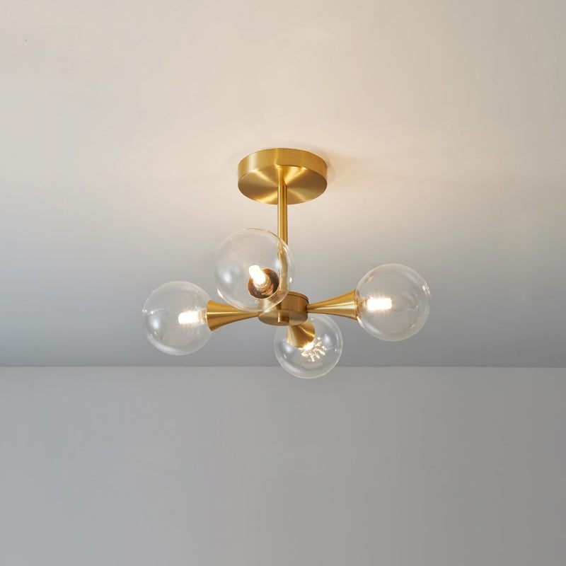 Contemporary glass bulb pendant light with brass fixture.