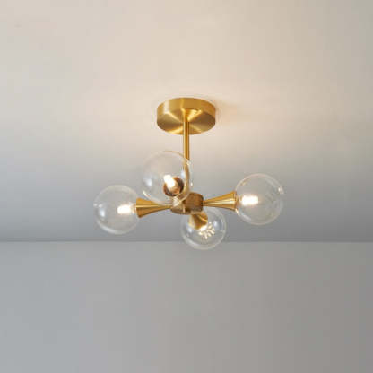 Contemporary glass bulb pendant light with brass fixture.