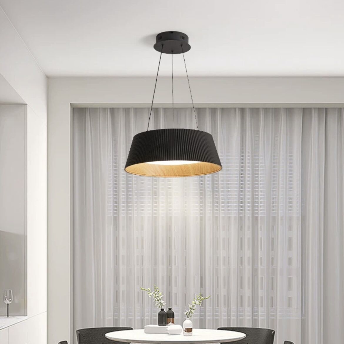 Black geometric pendant light. Alessio ceiling lamp in modern dining room.