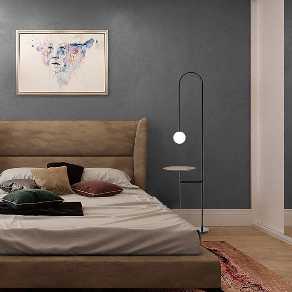 Minimalist floor lamp with table next to bed in modern bedroom