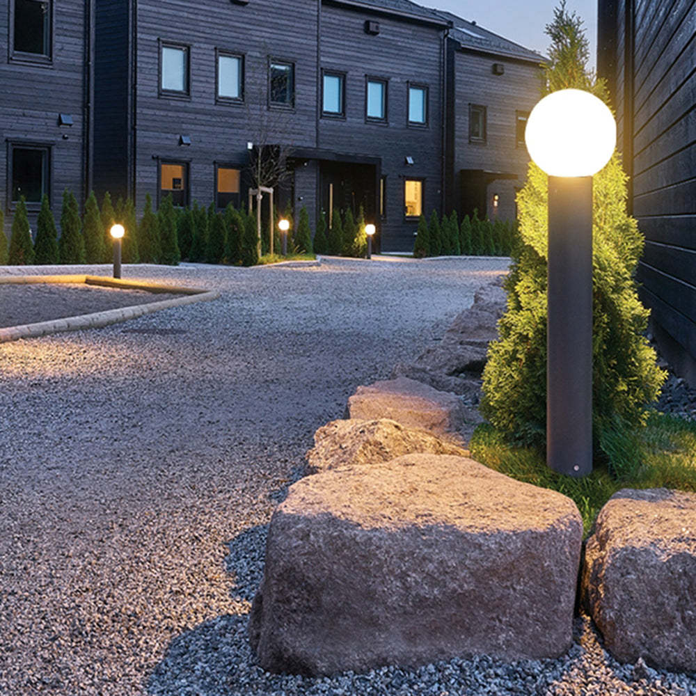 Pena Modern Outdoor Path Light illuminating a garden