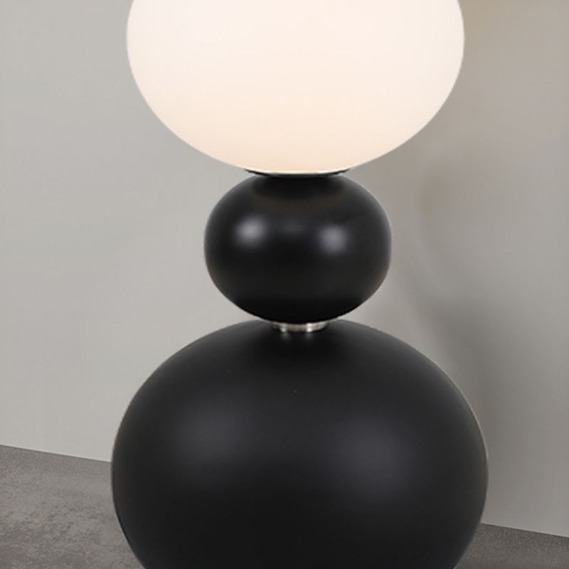 Valentina floor lamp: Black resin & white glass spheres.