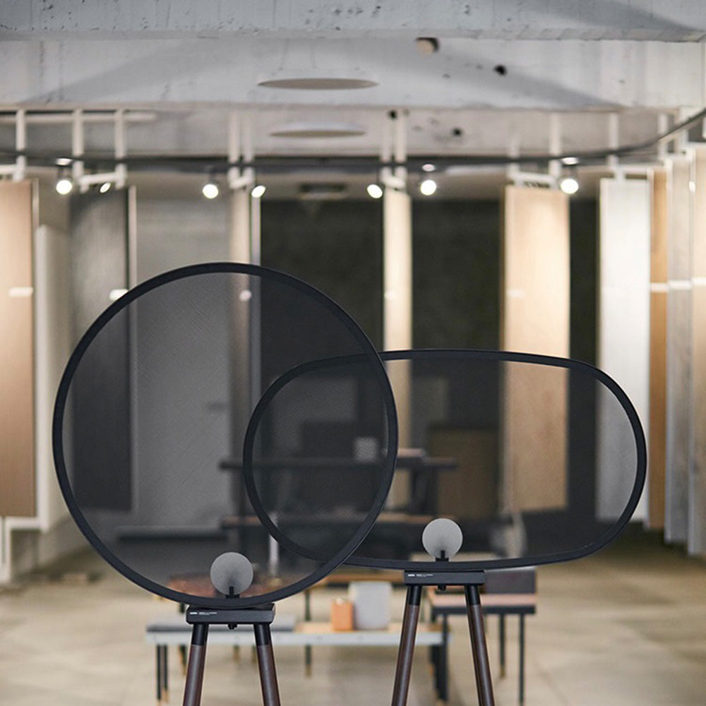 Cooley minimalistic floor lamp: metal mesh shade on wood legs.
