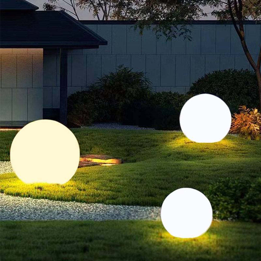 Outdoor globe lights illuminating a garden at night
