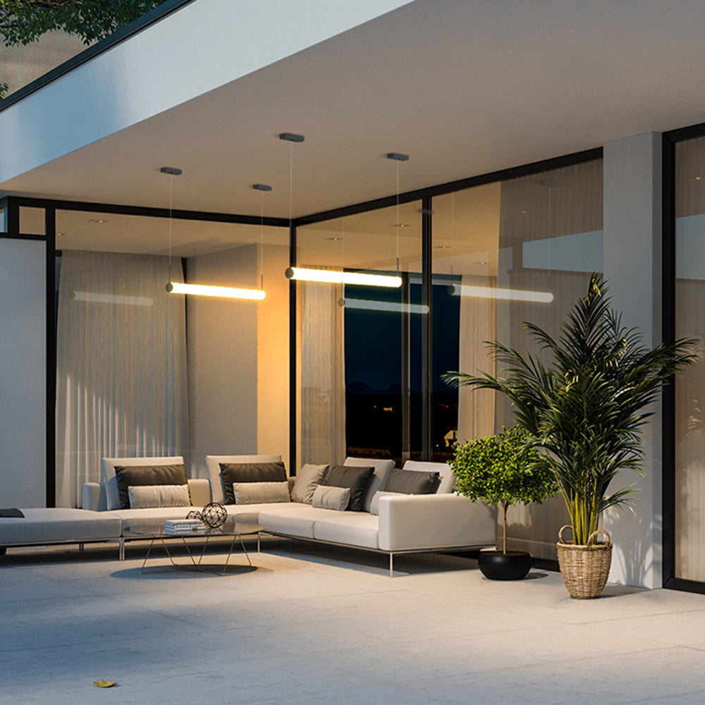 Cylinder pendant lights illuminate modern outdoor patio.