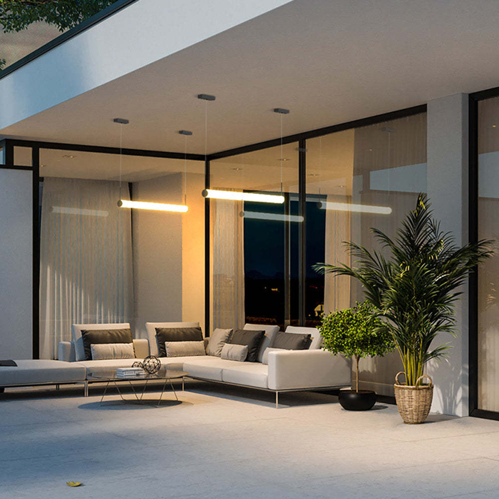 Cylinder pendant lights illuminate modern outdoor patio.