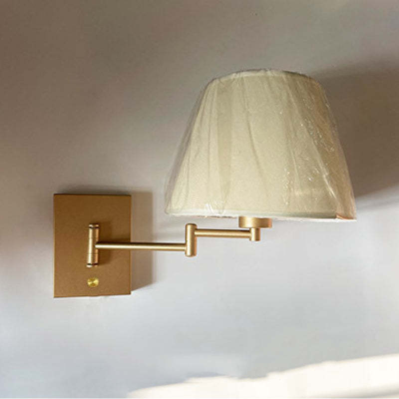 Brady gold wall lamp with fabric shade.