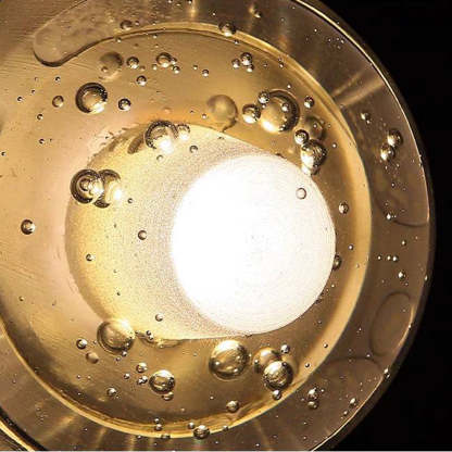 Valentina Outdoor Wall Lamp, transparent glass detail with bubbles and warm light.