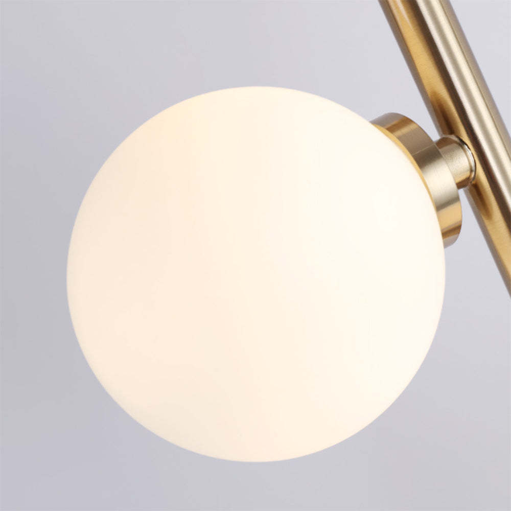Valentina floor lamp, close-up of glass globe lampshade and brass details