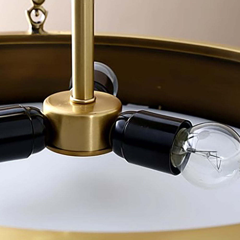Close-up of Quinn pendant light's bulb and holder, gold finish