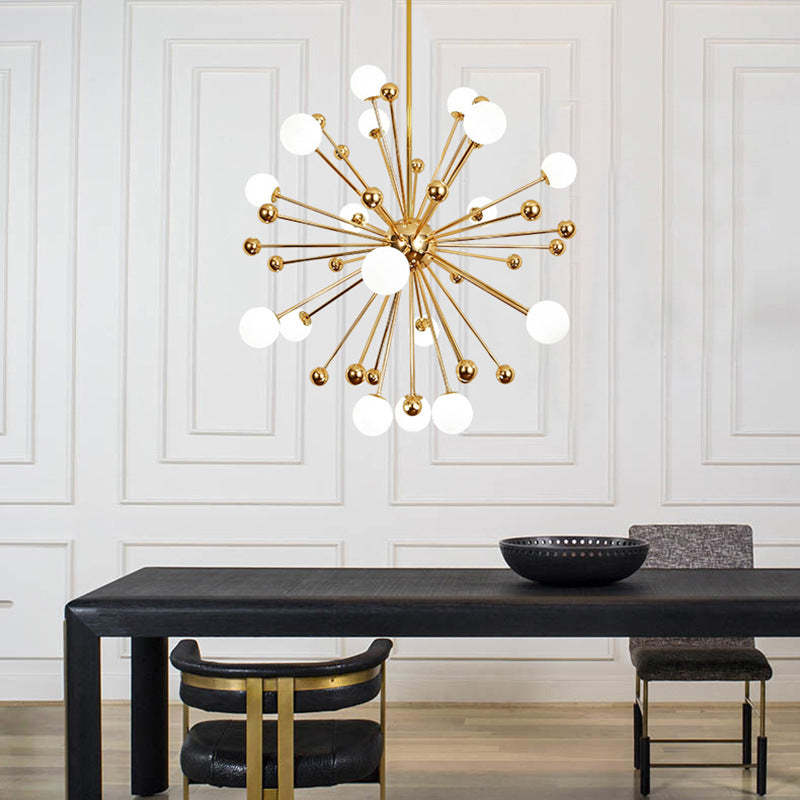 Alessio gold LED chandelier above a dining table. Modern lighting.