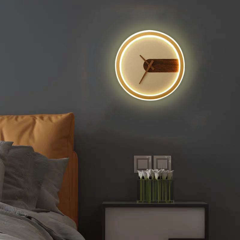Nielsen Modern Clock Design Wall Lamp in bedroom setting, with bedside table
