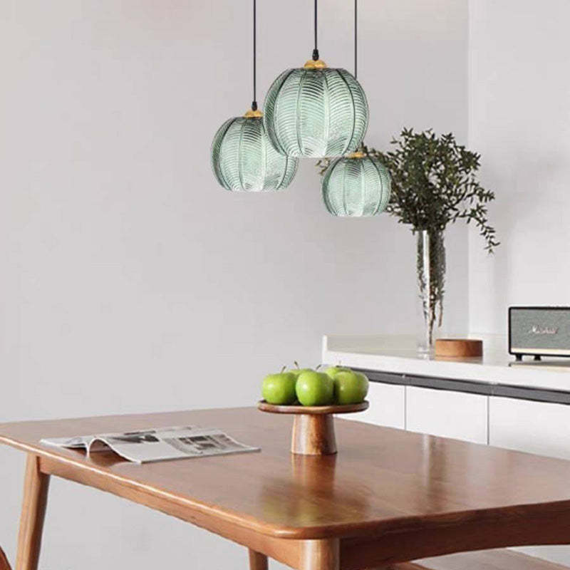 Nordic ribbed glass pendant lights above dining table