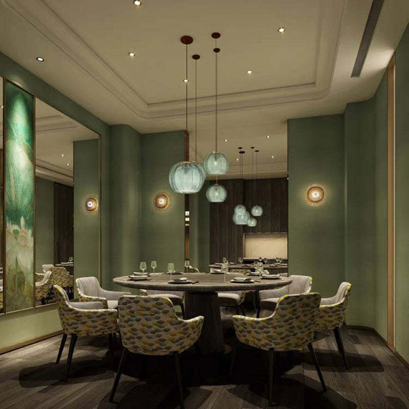 Ribbed glass pendant lighting over dining table