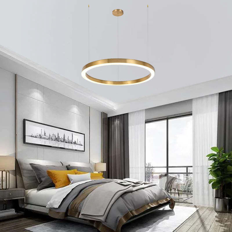 Arisha gold pendant light in a modern bedroom.