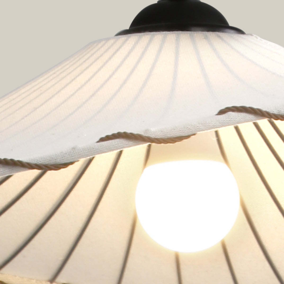 Close-up of white fabric Boho pendant light with LED bulb.