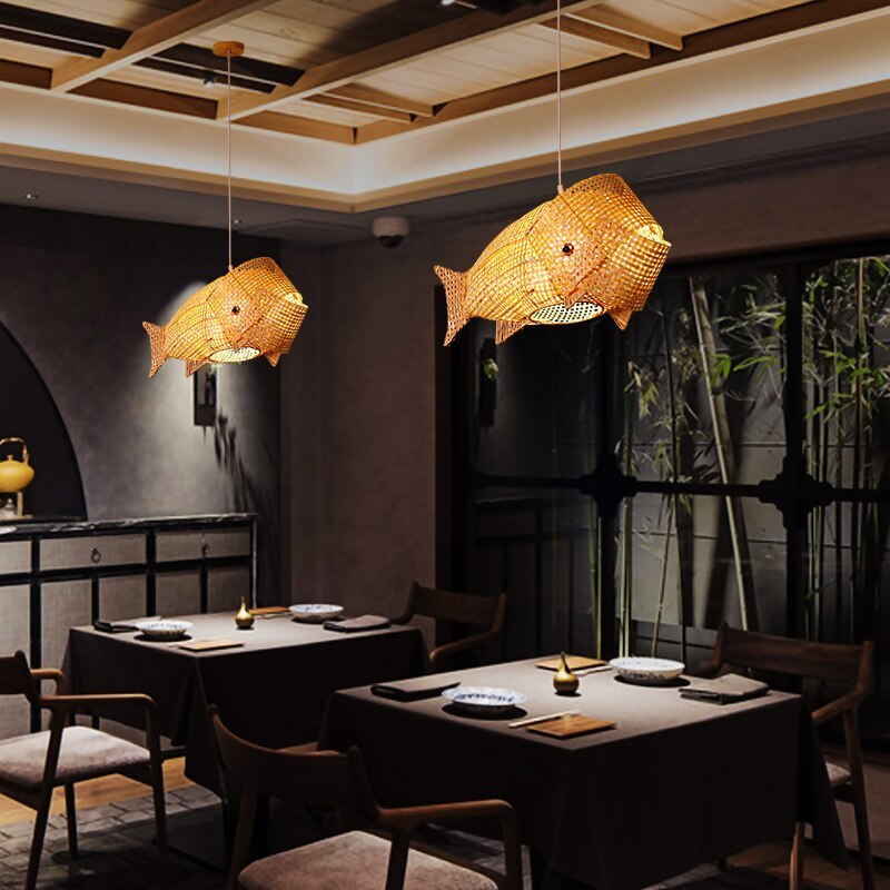 Rattan fish pendant lights in restaurant. Muto Art Deco lighting.
