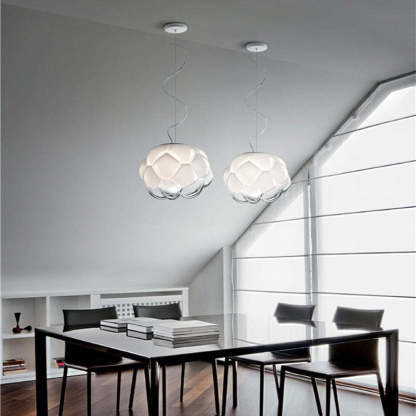 Two cloud-shaped glass pendant lights above dining table