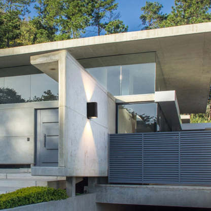 Orr minimalist outdoor wall lamp illuminating a modern home exterior.